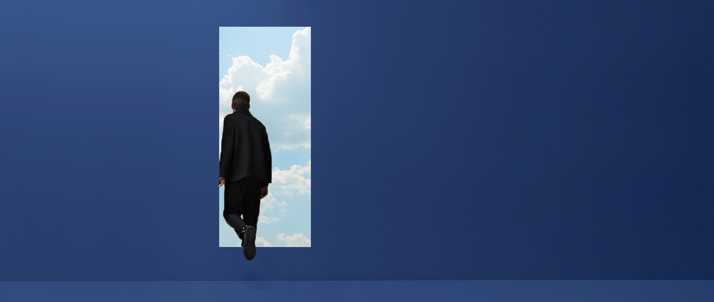 Man walking through a doorway into the clouds
