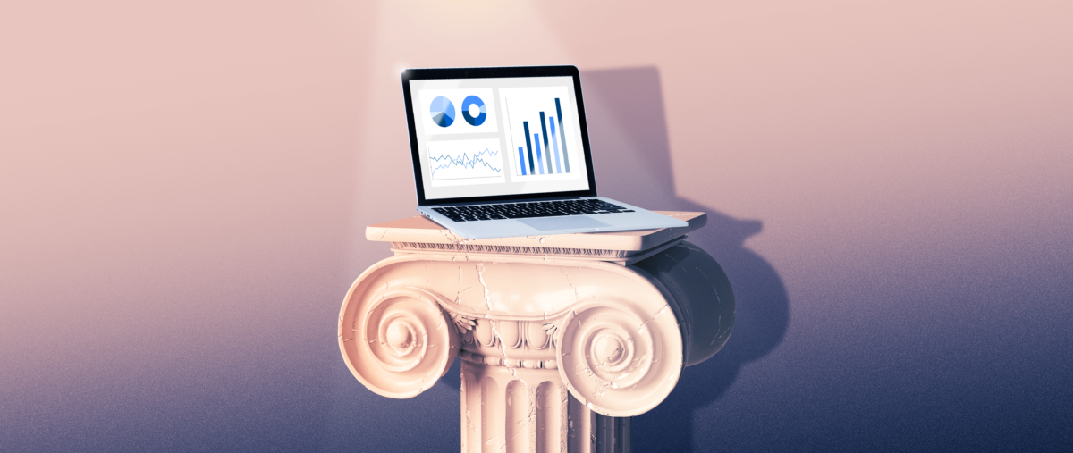 Laptop with financial content on screen sitting atop a pedestal